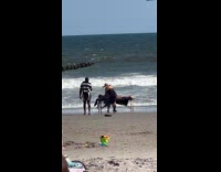 Person gets body massage by the beach