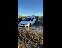 Car stuck in muddy ditch
