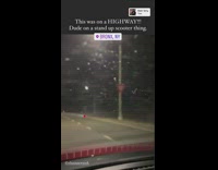 Guy rides electric scooter down freeway 