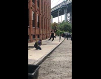 IITW - Guy jumps for a picture in front of DUMBO bridge in New York