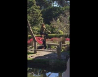Couple does yoga pose outside