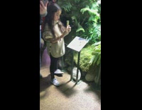 little girl takes picture of mom museum