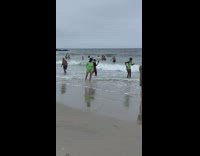 Bunch of dancers in green copy people at the beach