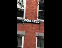 Black sign says invoke the 25th 