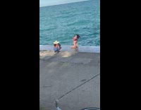 Woman bikini kneel ground beach straw hat