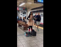 Submitter shows woman busking at train platform 