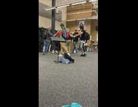 Students hold hands and walk around teacher 