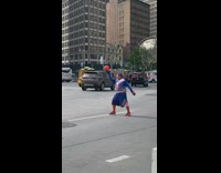 Blue shorts guy holds ball human statue 