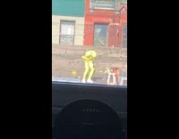 Person in full body yellow outfit doing a dance on the rooftop