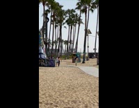Girl does dance pose at beach