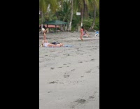 Woman in pink bikini headstand twerk at the beach