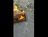 Cooking beef roast on pan off of grill on floor