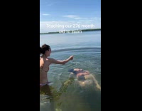 Girl teaching friend to swim 