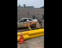 Collab WINY - Two guys push white car on street beside construction