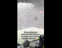 Woman watches football with husband during snow