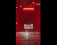 Custom white license plate says jus fine 