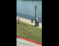 Two woman upside down workout park ocean