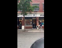 Man playing bagpipes with people marching behind him