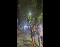 Woman in red tube top lie down on the sidewalk