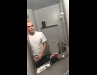 Man rapping and making weird noises in bathroom mirror
