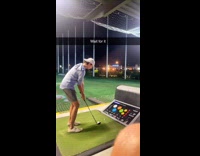 Guy top golf hits orange juice bottle