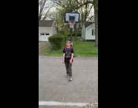 Boy throws basketball behind head makes it 