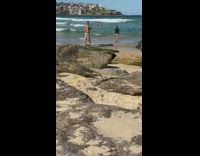 Black shirt guy dunks entire body ocean 