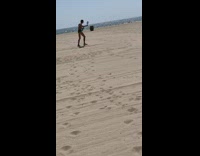 Collab Kook Of The Day - Guy handheld mirror black shorts beach sand