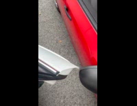 Guy opens car door near side mirror