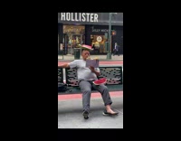 Guy sits on bench with watermelon on head