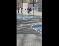 Men filming music video on basketball court 