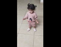 Toddler girl walk and try to jump