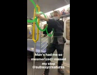Street performer with three green rings subway 
