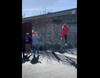 Woman red coat hang gate dance music