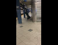 Black jacket guy does handstand subway platform 