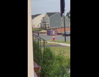 Girl yellow vest hat spin hoop hydrant