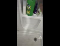 Guy scrubs his foot in shower 