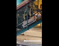 two guys beige couch green stairs