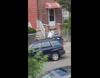 Lady wearing blue gloves sprays disinfecting spray 