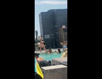 Woman in bikini leans and twerks at the poolside