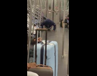 Guy does push ups on subway floor 