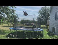 Guy backflips on outdoor backyard trampoline and lands on inflatable mattress