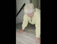 Grandma crawling on floor of house 