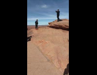 Guy has photoshoot with desert rocks