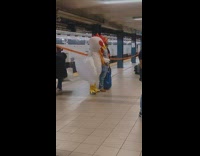 Chicken giant mascot stand and wait for the train in subway NY 