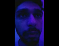 Guy stares colorful flashing lights 