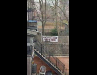 Sign in backyard that says capitalism kills fun