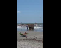 Girl sits stool brown backdrop beach sand