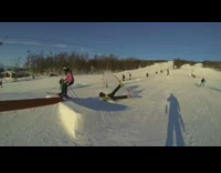 Green Jacket Skiier Tries to Grind Rail and Falls Down