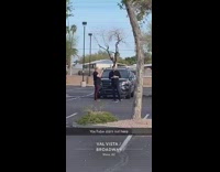 man films black car parking lot